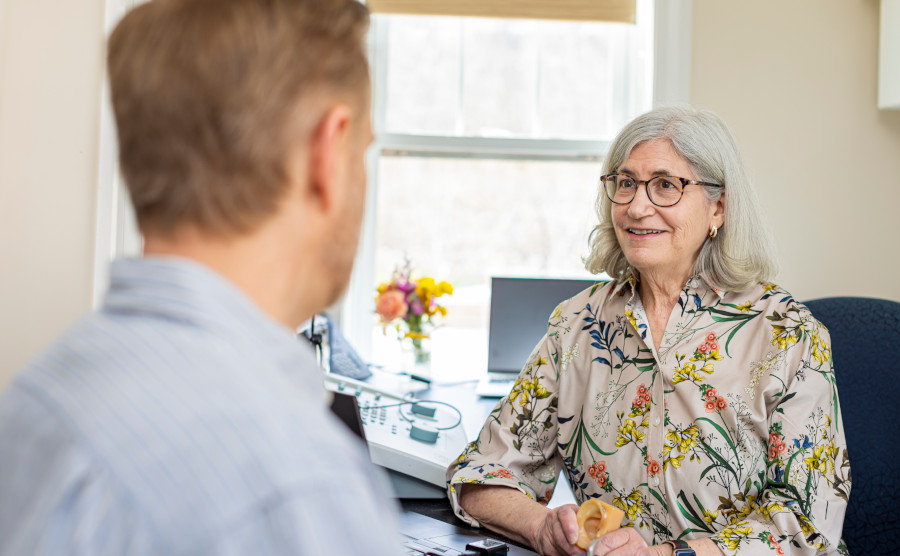 Dr. Segal speaking with a male patient about hearing better